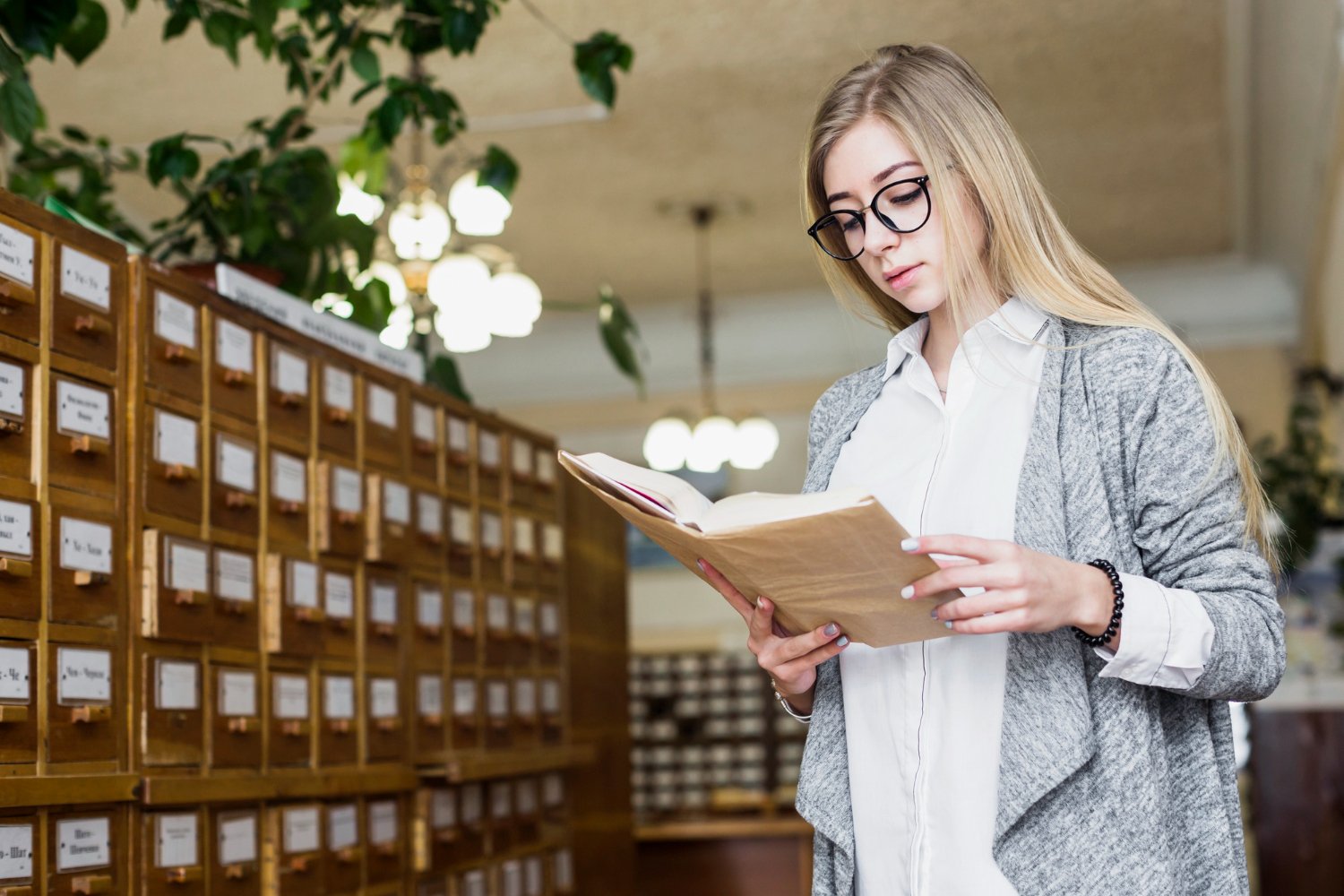 charming woman enjoying reading library