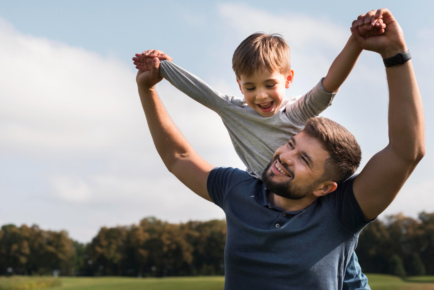 father son having good time park