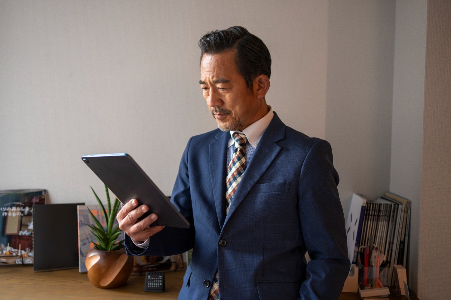 medium shot business man holding tablet